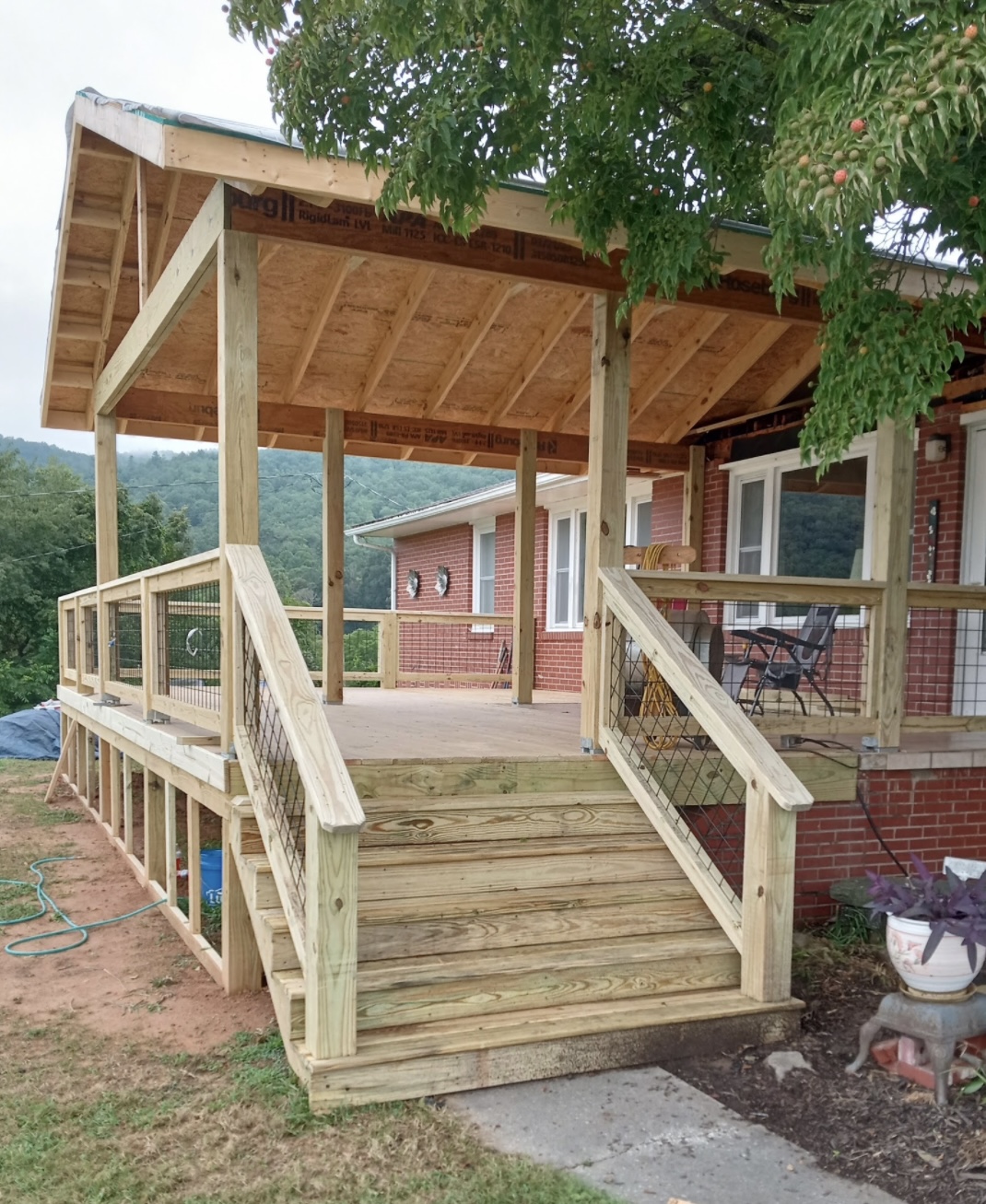 Covered porch under construction with LVL framing — brick ranch home, WNC