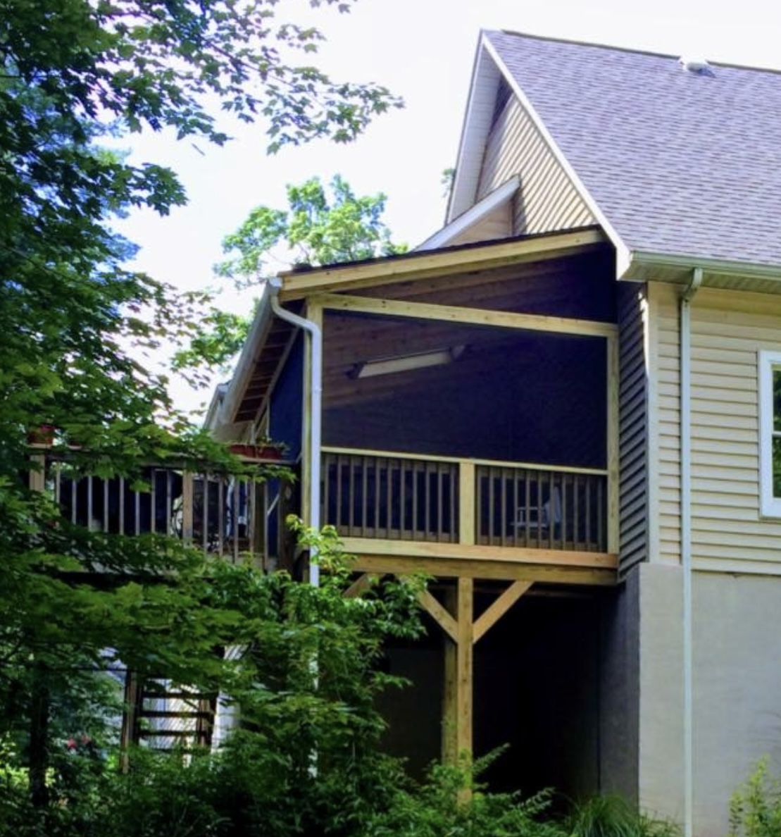 Elevated screened porch addition in wooded WNC setting
