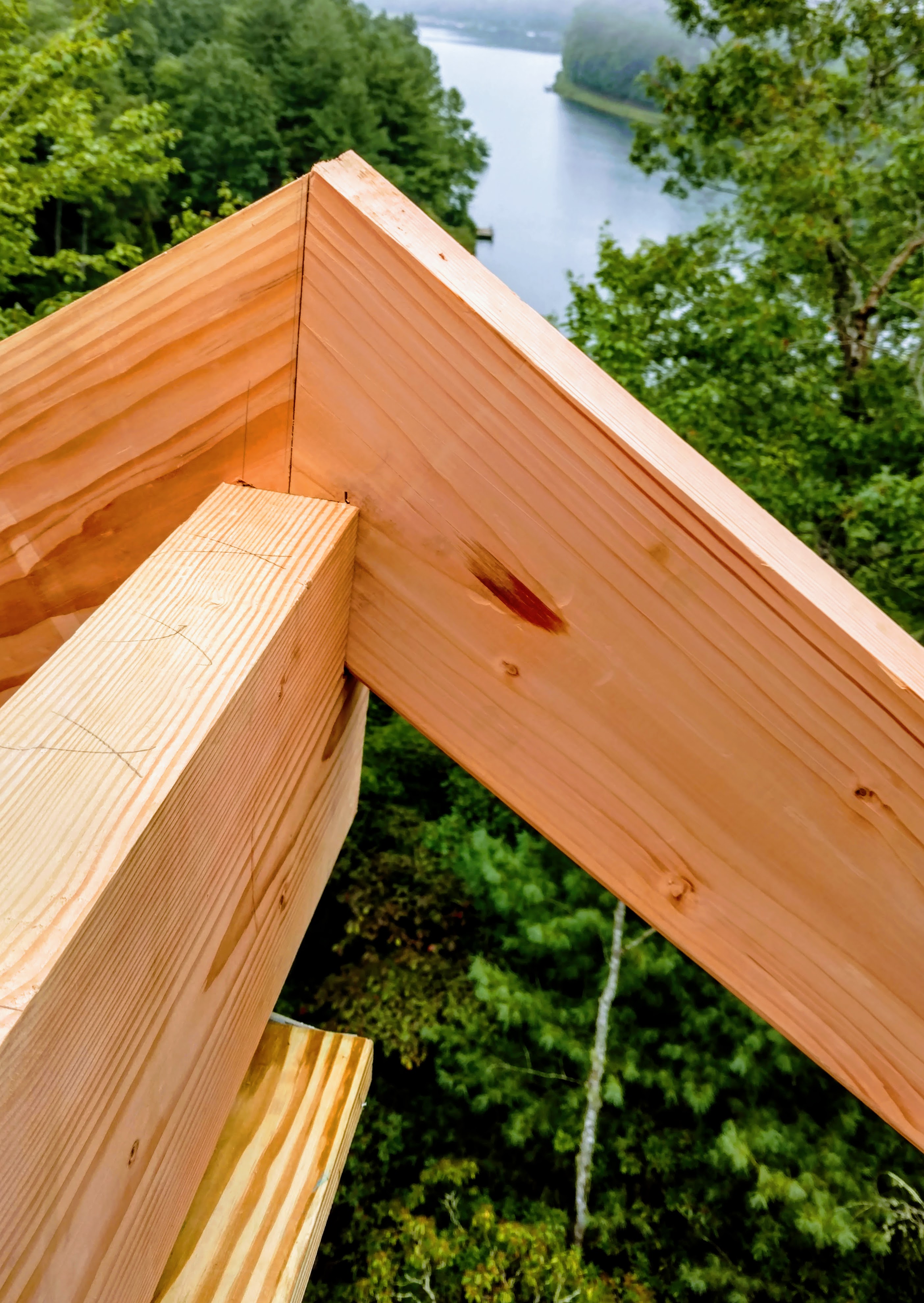 Precision beam corner joinery over WNC lake — Big Moose Construction